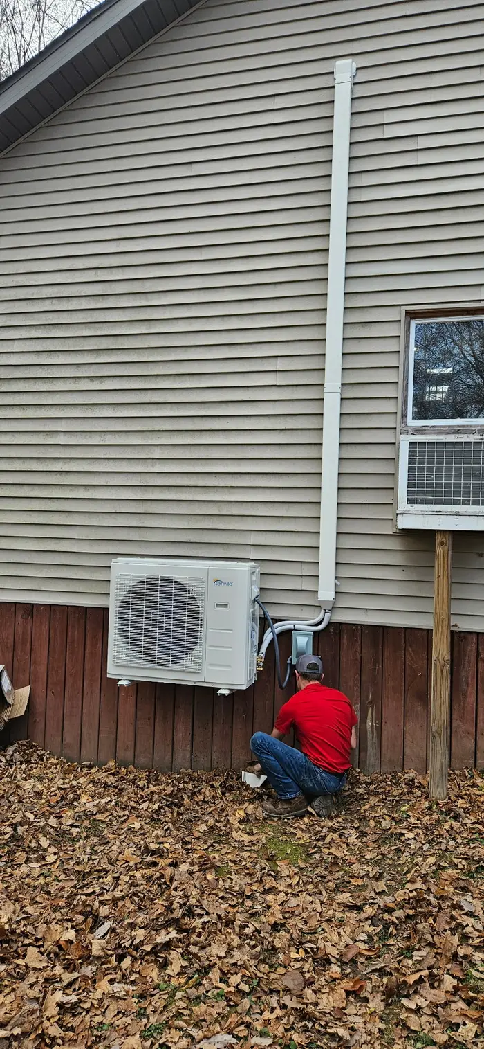 AirSorce-1 technician installing mini-split outdoor unit on residential home in Terre Haute Indiana